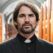 Christian priest standing by the altar